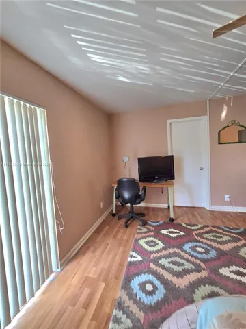 a bedroom with a bed and a chair