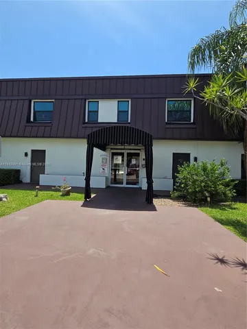 a view of a house with a yard and a garage