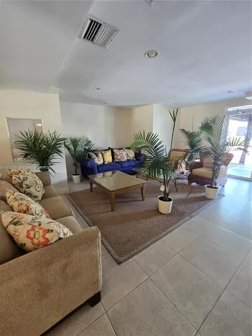 a living room with furniture and flowers
