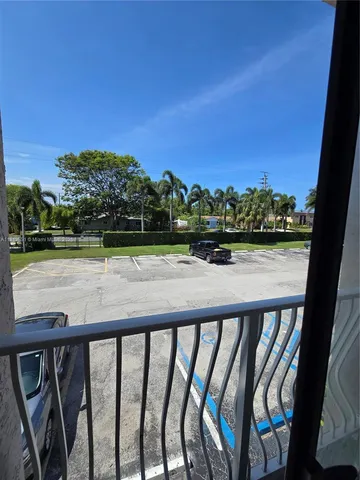 a view of a park with bench and trees