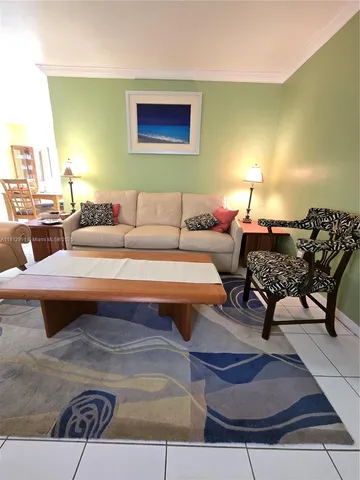 a living room with furniture and a lamp