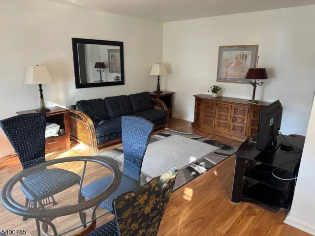 a bedroom with furniture and a wooden floor