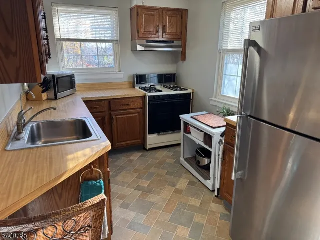 a kitchen with a sink a stove and refrigerator