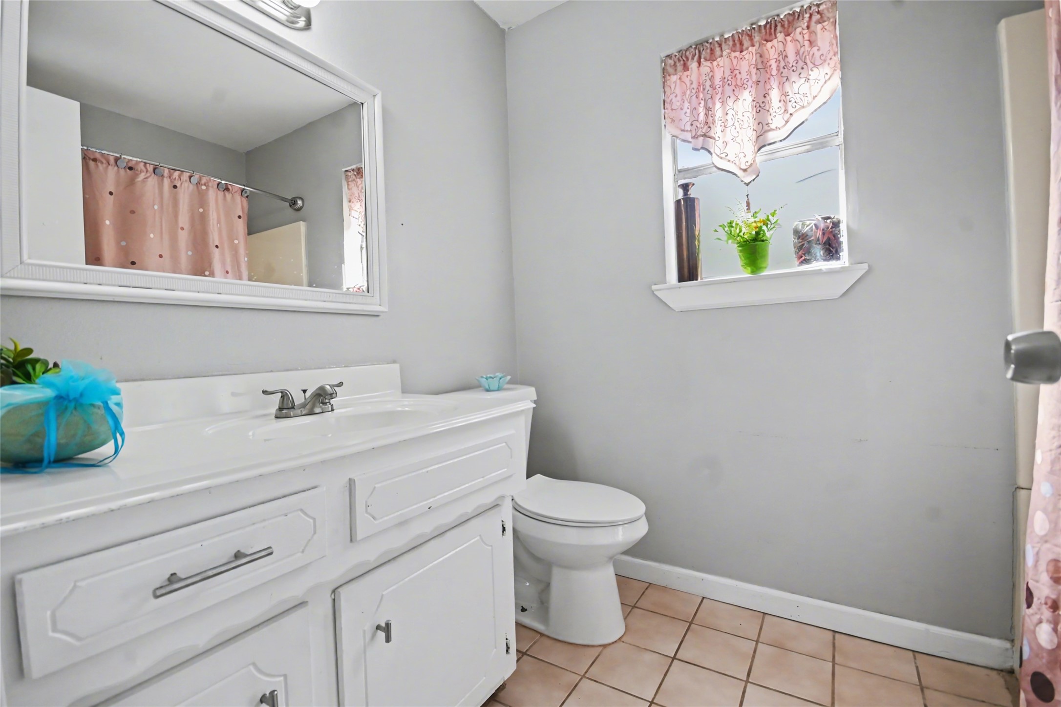 4202 Townes Forest Road Friendswood, TX 77546 - Photo 13 of 17 a bathroom with a toilet sink and mirror