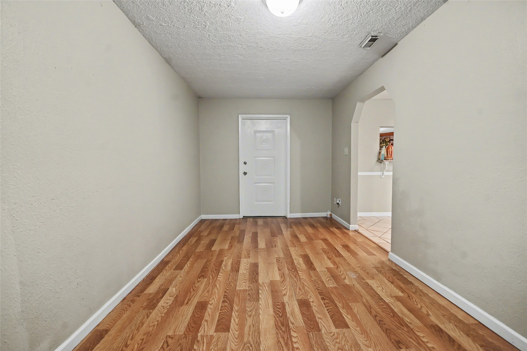 4202 Townes Forest Road Friendswood, TX 77546 - Photo 5 of 17 a view of a room with wooden floor and white walls