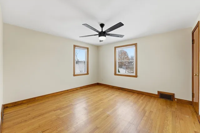 a view of room with hardwood floor and ceiling fan