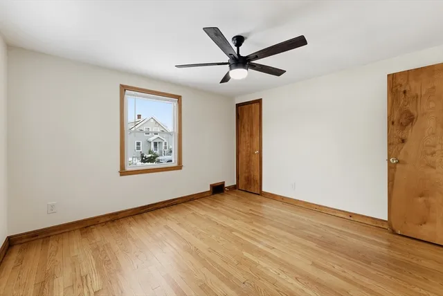 a view of a big room with wooden floor closet and windows