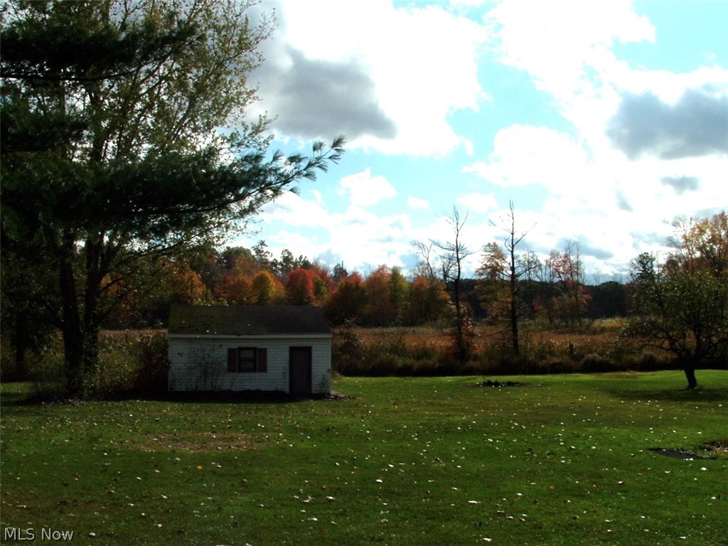 4486 Hayes Road Ravenna, OH 44266 - Photo 26 of 26 View of outbuilding/additional garage and the flat, private, and peaceful rear yard. Home sits on a full acre of land.