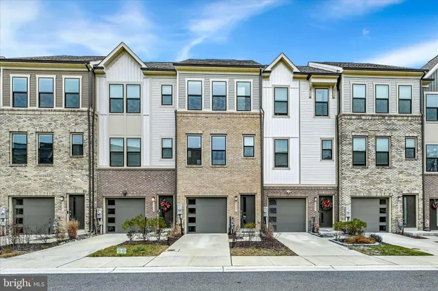 a front view of a residential apartment building with a yard