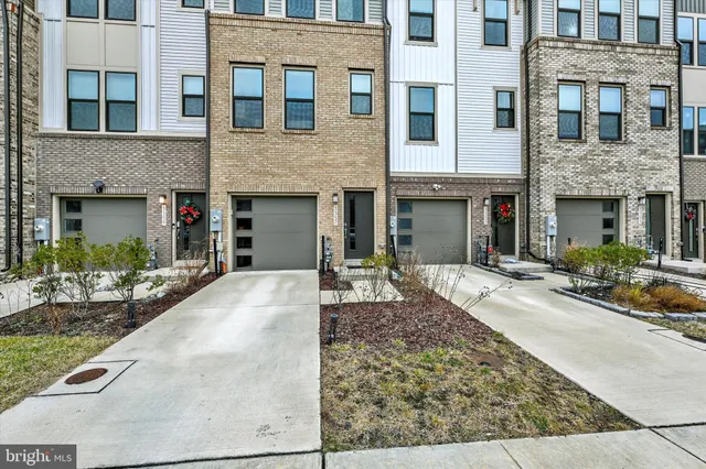 a front view of a house with outdoor seating and plants