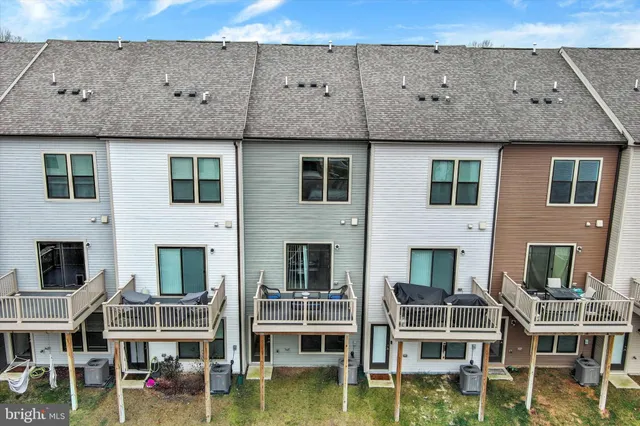 a view of a patio with swimming pool and sitting area