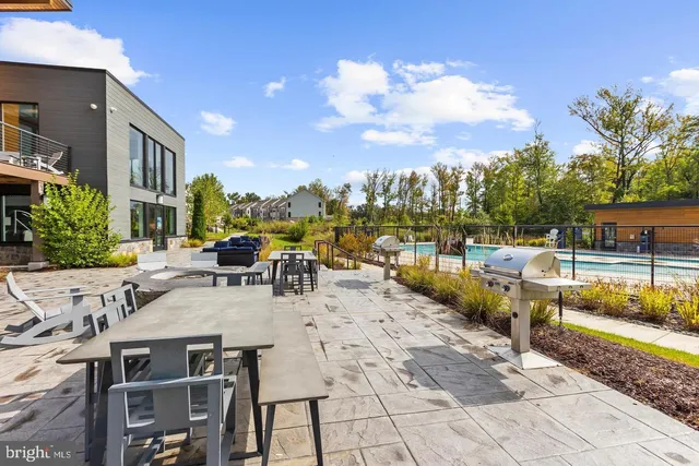 a front view of a building with glass windows and lake view