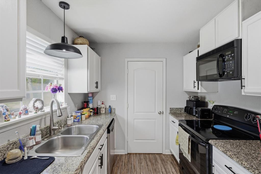 123 Harmon Road Gun Barrel City, TX 75156 - Photo 18 of 36 a kitchen with granite countertop a sink stove and cabinets