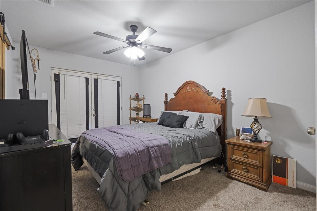 123 Harmon Road Gun Barrel City, TX 75156 - Photo 20 of 36 a bedroom with a bed and a chandelier