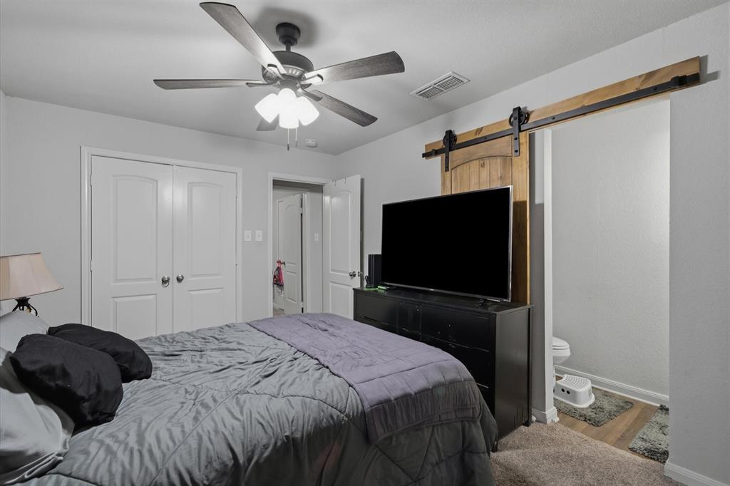 123 Harmon Road Gun Barrel City, TX 75156 - Photo 21 of 36 a bedroom with a bed window and a flat screen tv