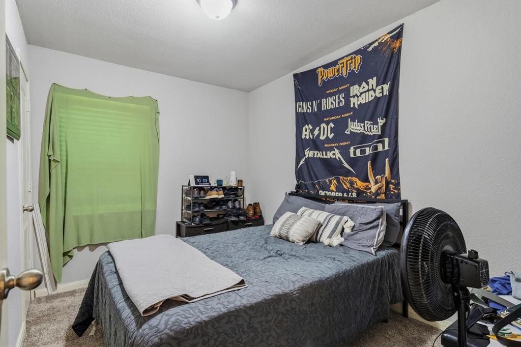 123 Harmon Road Gun Barrel City, TX 75156 - Photo 24 of 36 a bedroom with a bed and a dresser