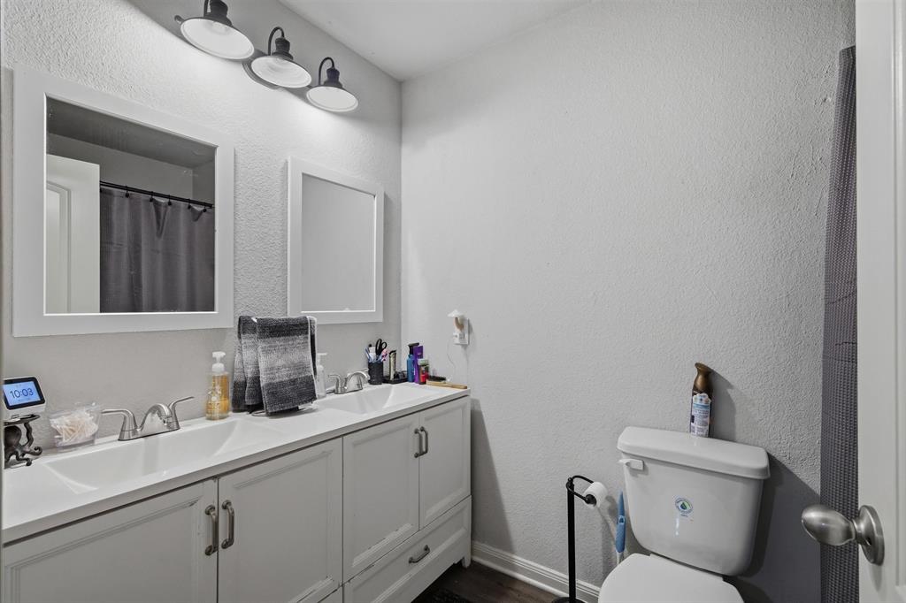 123 Harmon Road Gun Barrel City, TX 75156 - Photo 25 of 36 a bathroom with a toilet sink and mirror