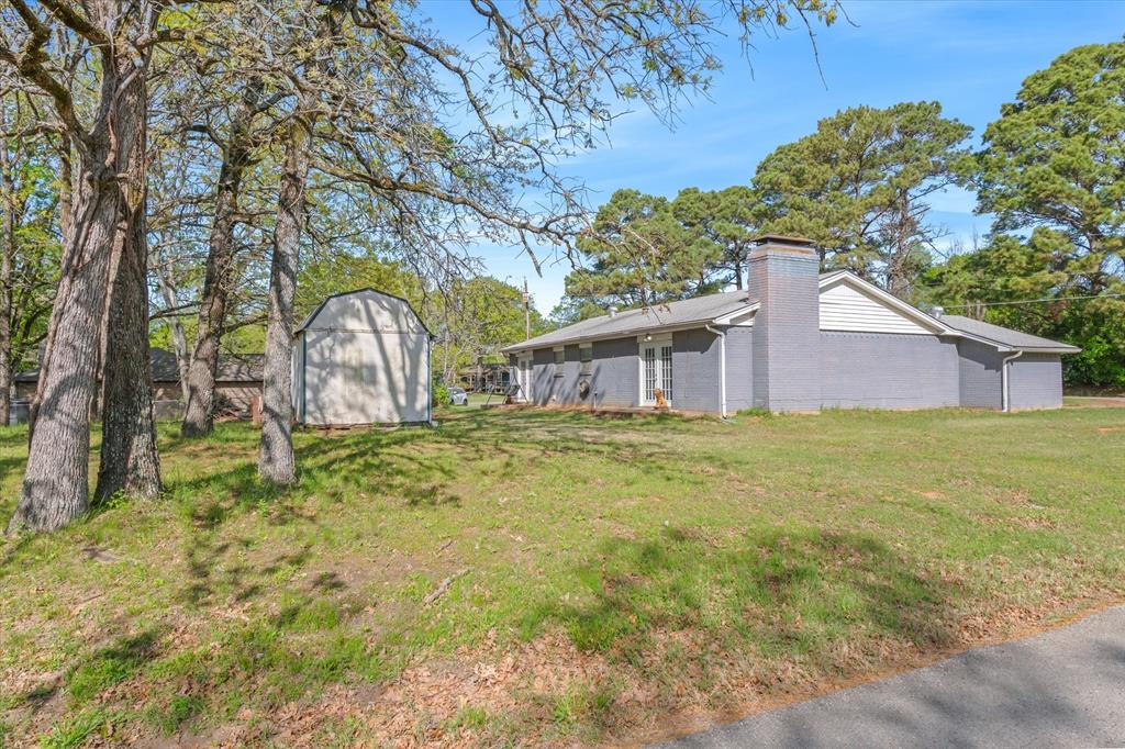 123 Harmon Road Gun Barrel City, TX 75156 - Photo 32 of 36 a front view of house with garden space and trees in the background