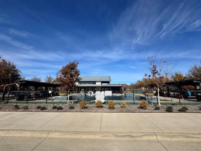 a view of swimming pool with outdoor seating and plants