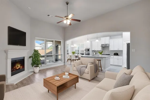 a kitchen with a dining table chairs stainless steel appliances and cabinets
