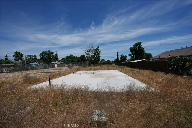 a view of swimming pool with outdoor seating and covered with trees in the background