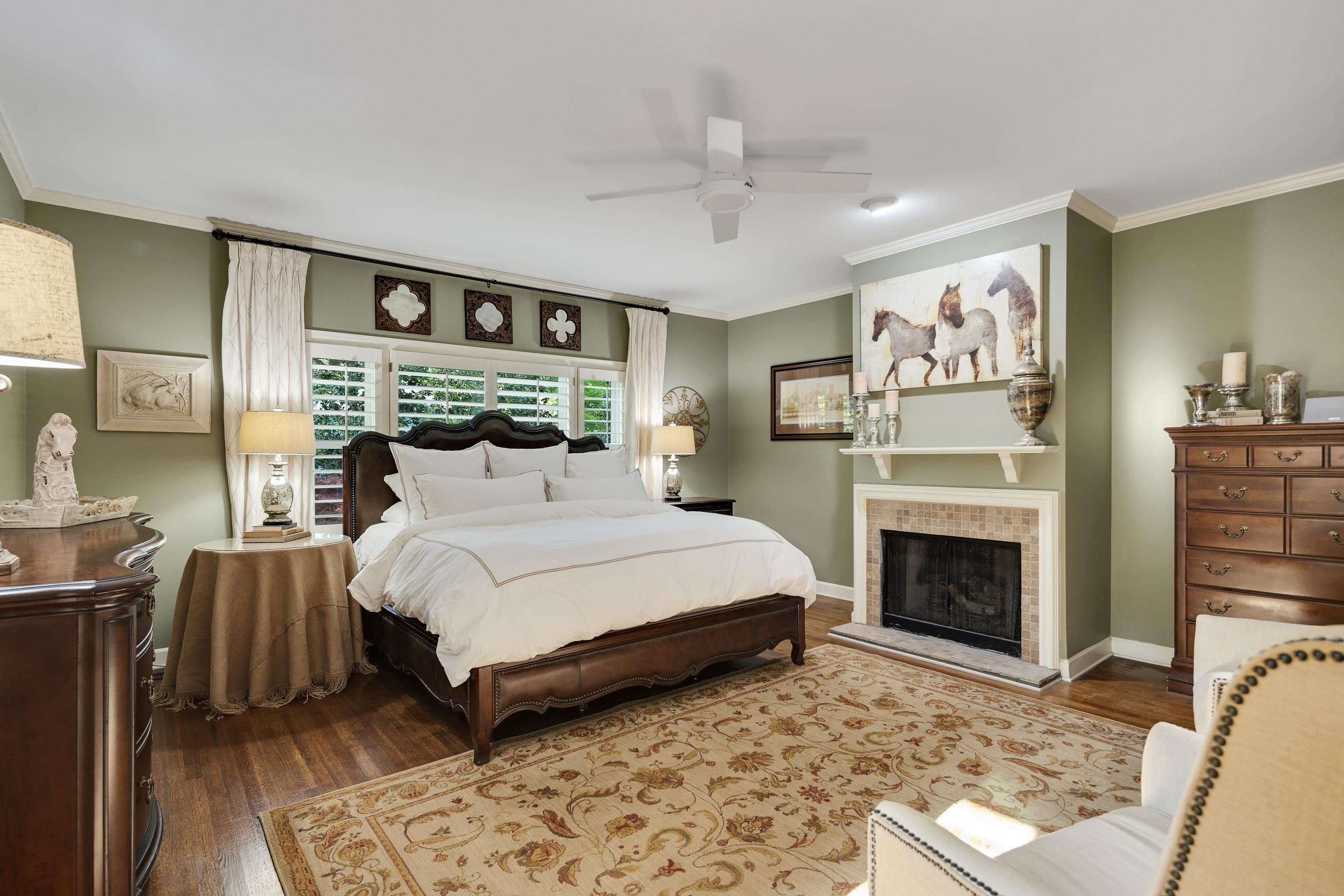 6326 East Shady Grove Road Memphis, TN 38120 - Photo 16 of 40 a bed room with a bed and a fireplace