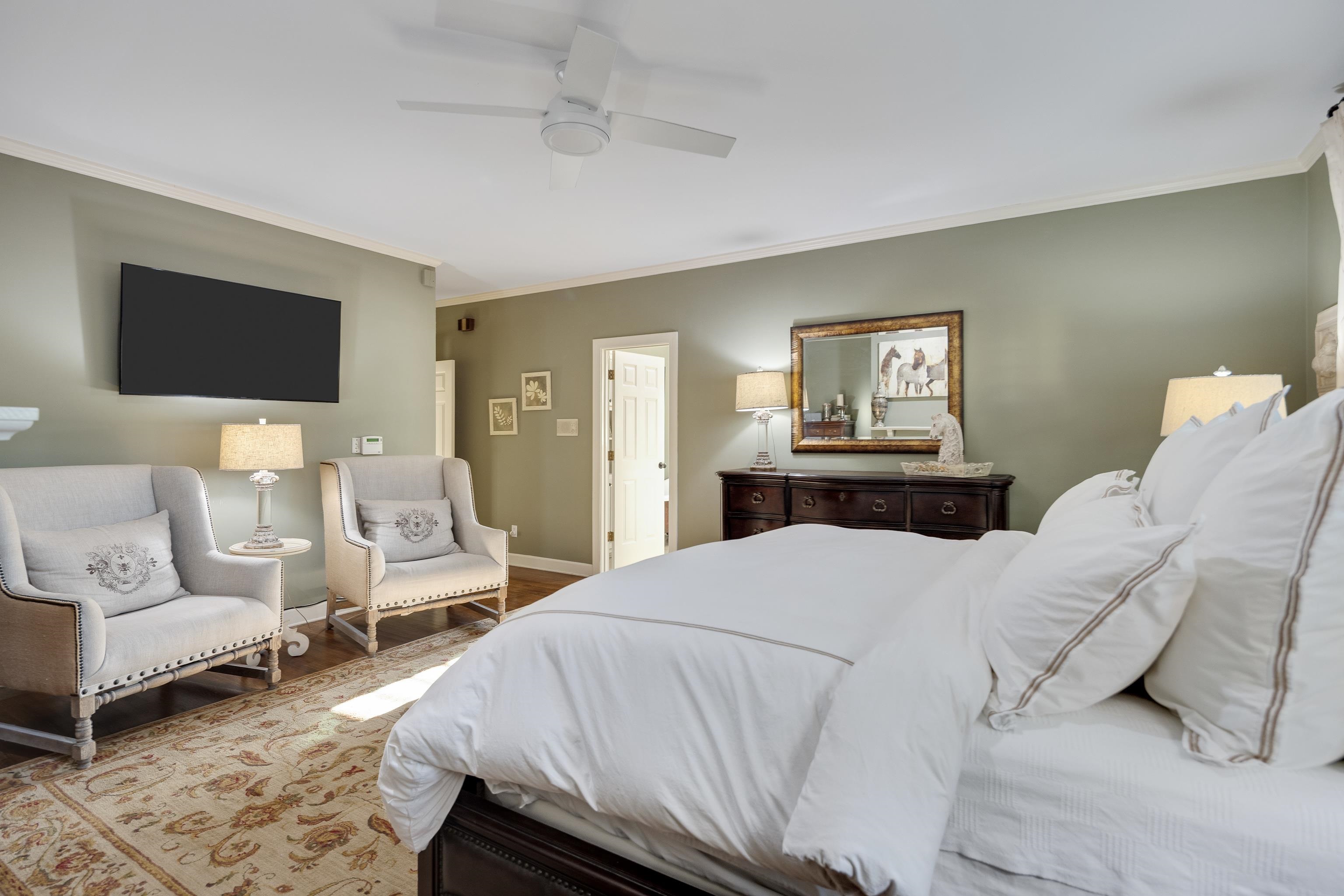 6326 East Shady Grove Road Memphis, TN 38120 - Photo 17 of 40 a bedroom with a bed and a flat screen tv