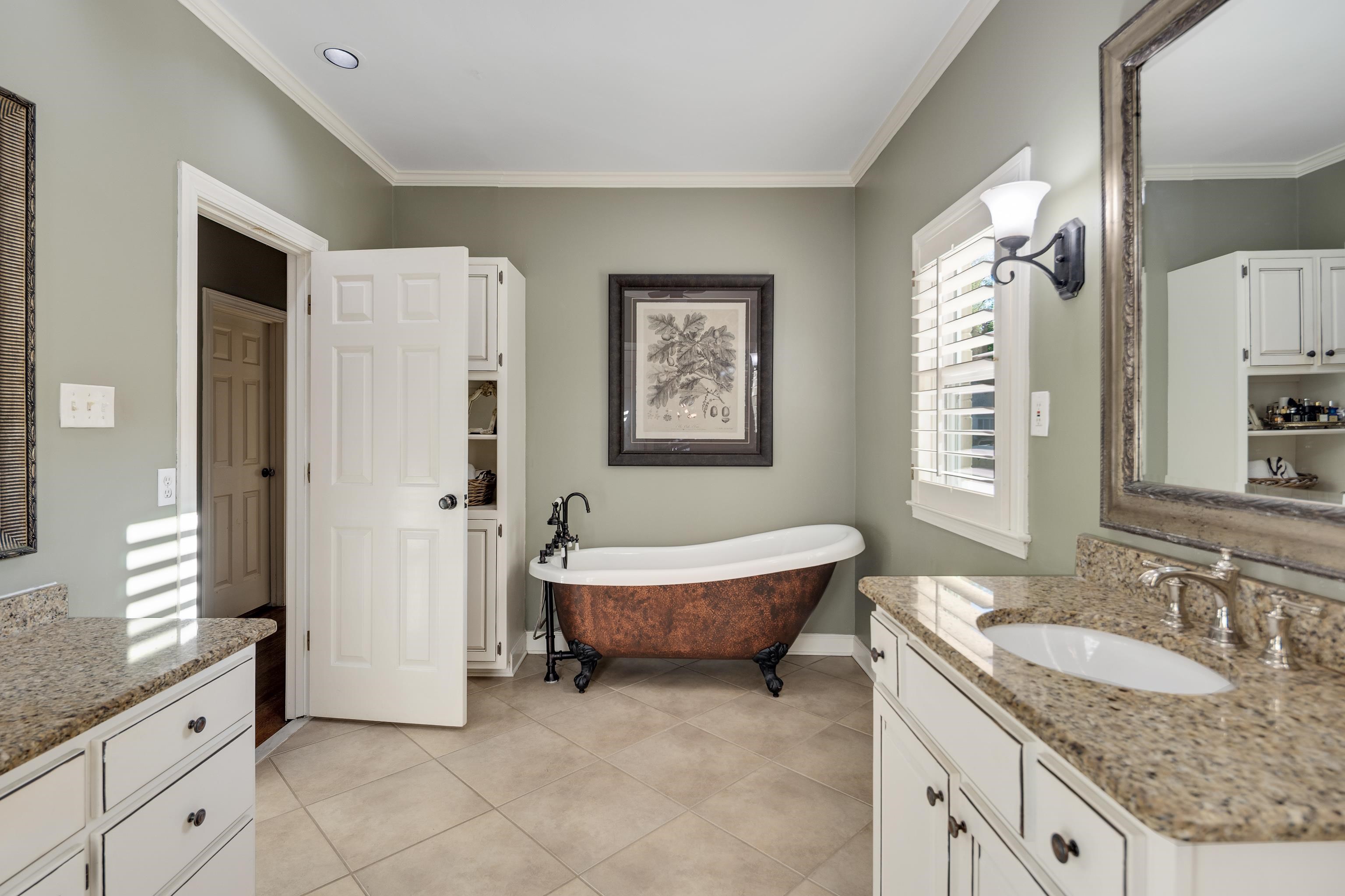 6326 East Shady Grove Road Memphis, TN 38120 - Photo 19 of 40 a spacious bathroom with a granite countertop sink and a mirror
