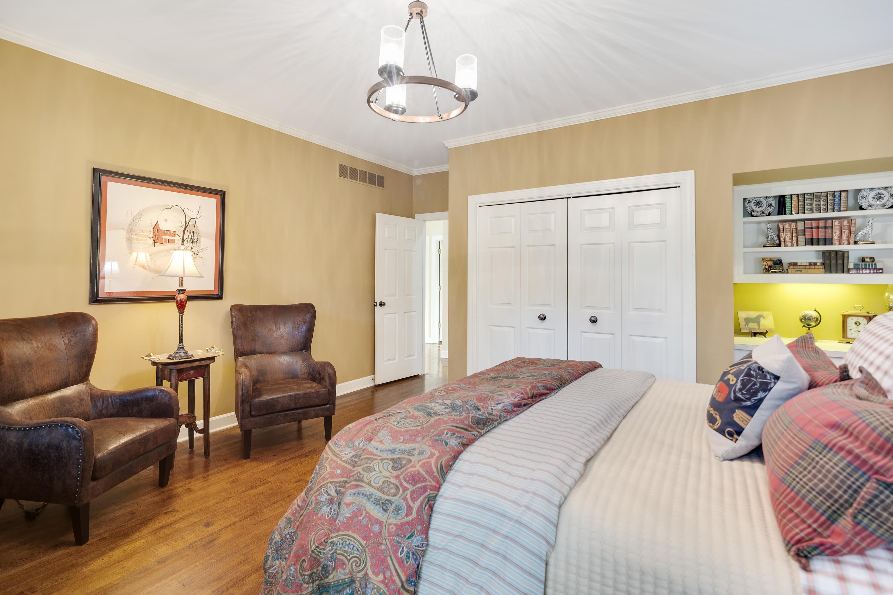 6326 East Shady Grove Road Memphis, TN 38120 - Photo 21 of 40 a bedroom with a bed and wooden floor