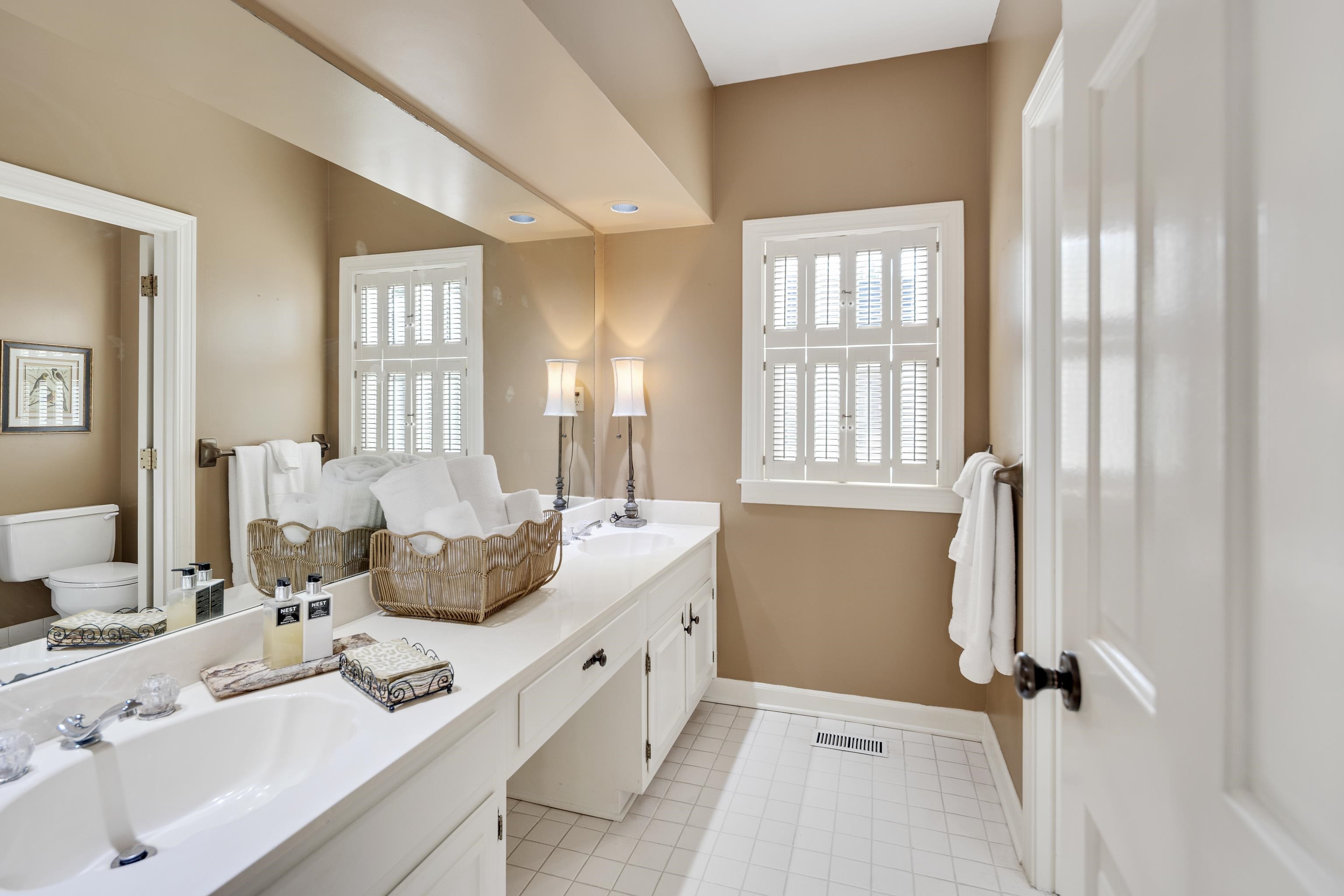 6326 East Shady Grove Road Memphis, TN 38120 - Photo 22 of 40 a spacious bathroom with double vanity and a mirror