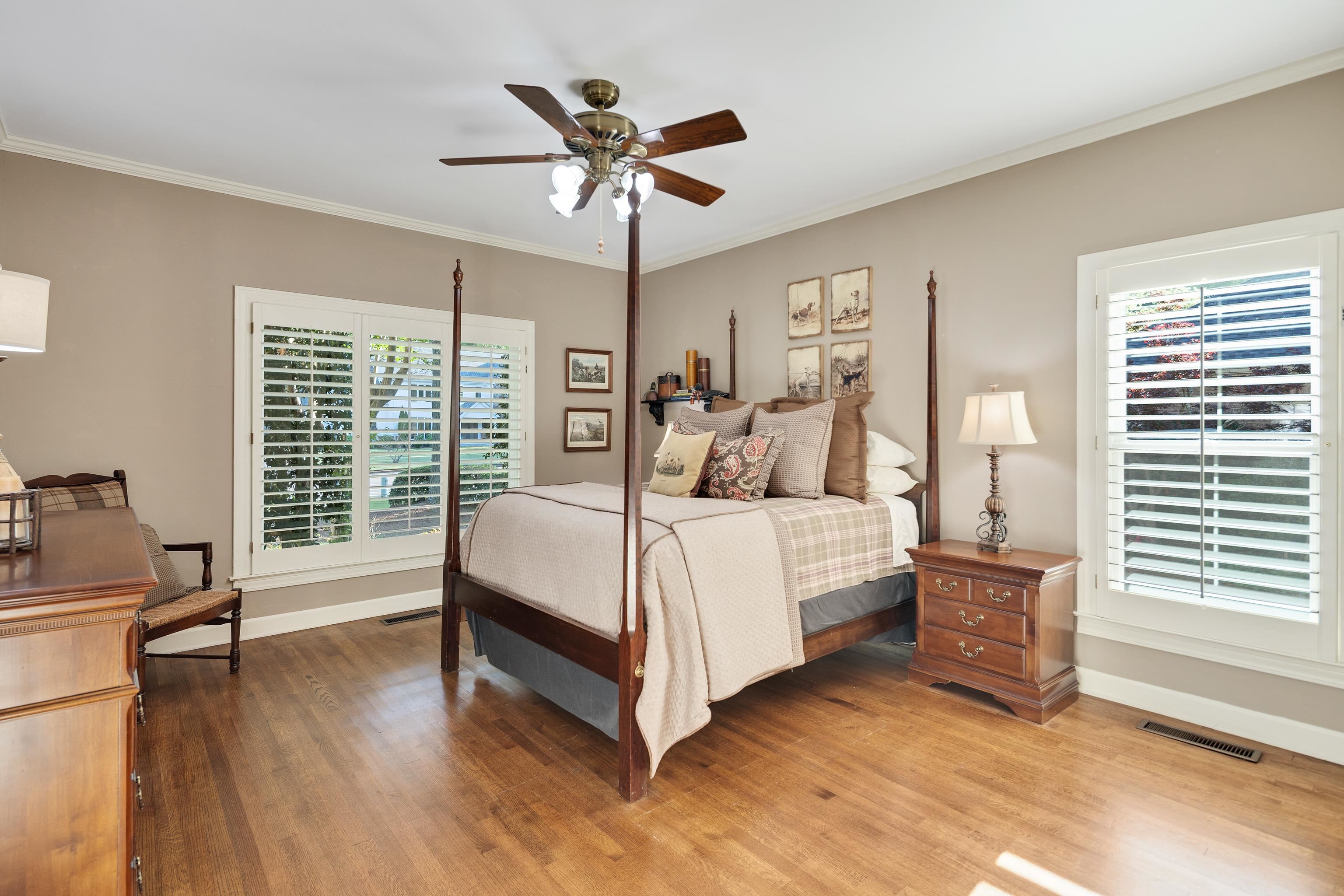 6326 East Shady Grove Road Memphis, TN 38120 - Photo 23 of 40 a bedroom with a large bed a chandelier and a window