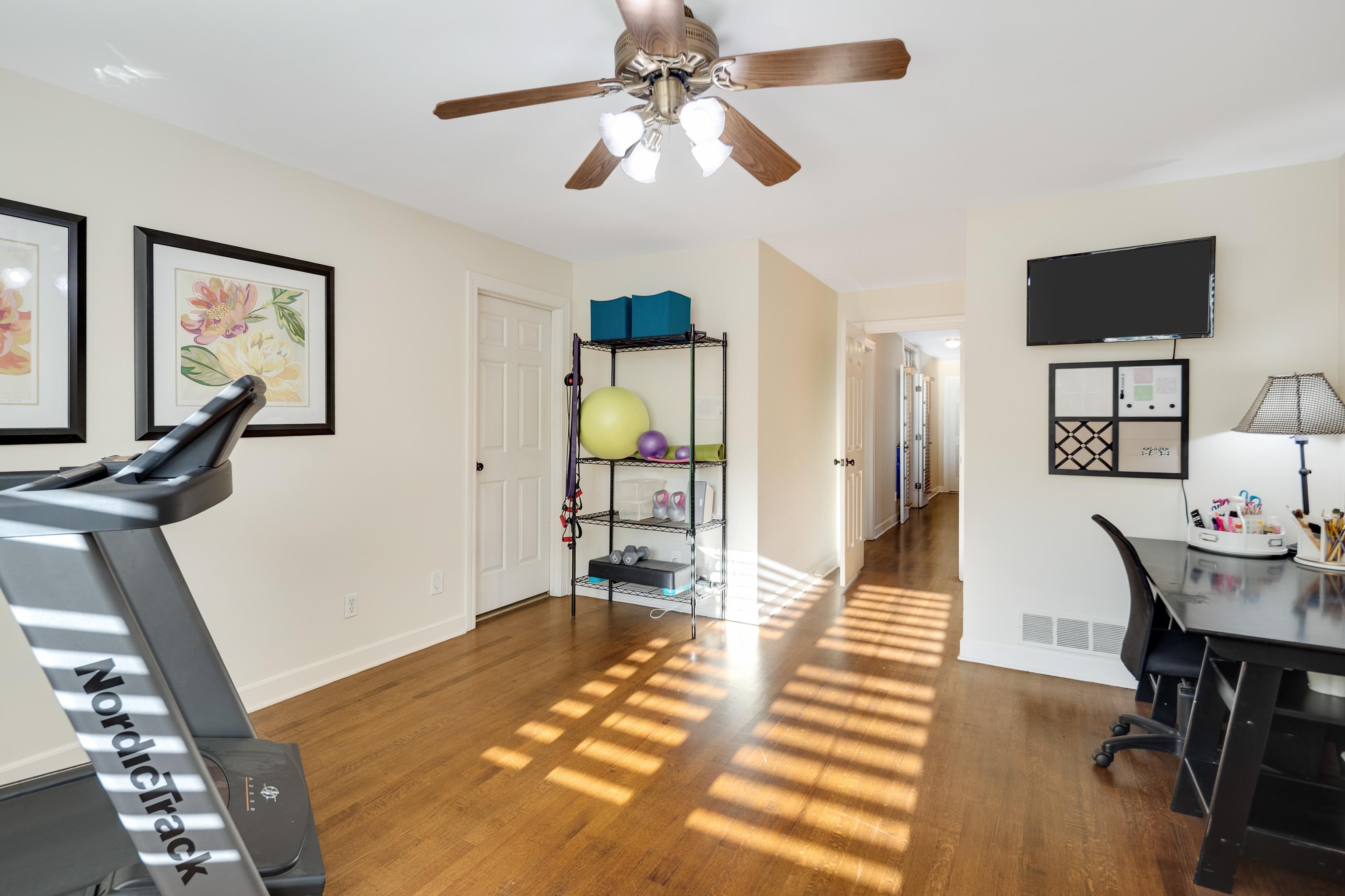 6326 East Shady Grove Road Memphis, TN 38120 - Photo 28 of 40 a dining room with wooden floor a chandelier a wooden table and chairs