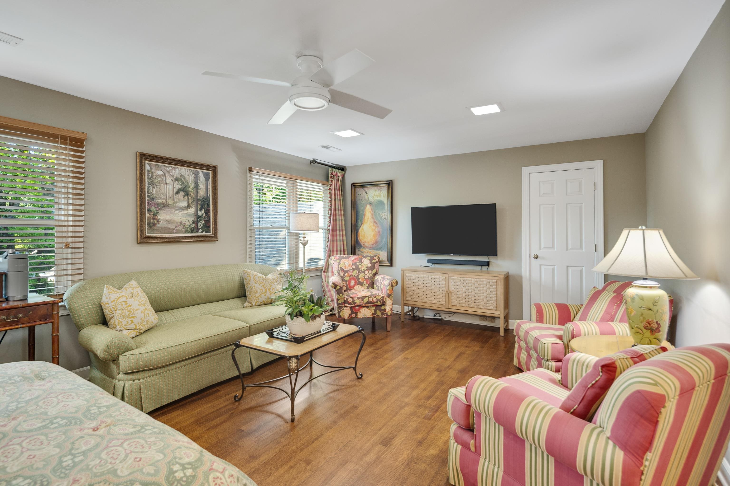 6326 East Shady Grove Road Memphis, TN 38120 - Photo 30 of 40 a living room with furniture a flat screen tv and a window