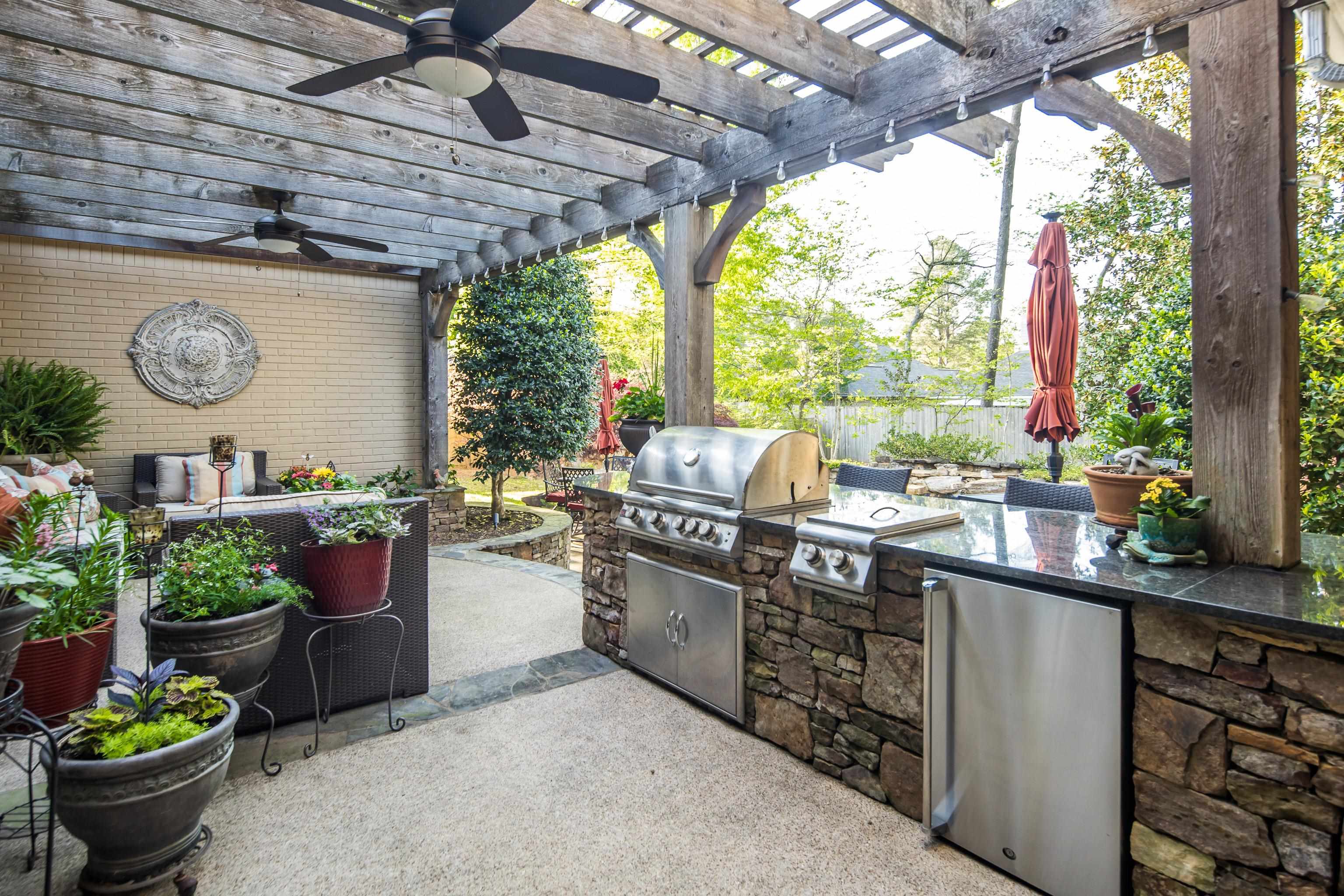 6326 East Shady Grove Road Memphis, TN 38120 - Photo 32 of 40 a kitchen with a stove a sink and a table and chairs