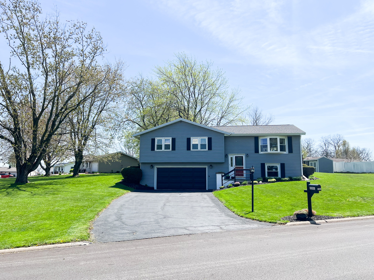 2201 Oak Drive Eureka, IL 61530 - Photo 2 of 25 a view of a brick house with a big yard plants and large trees