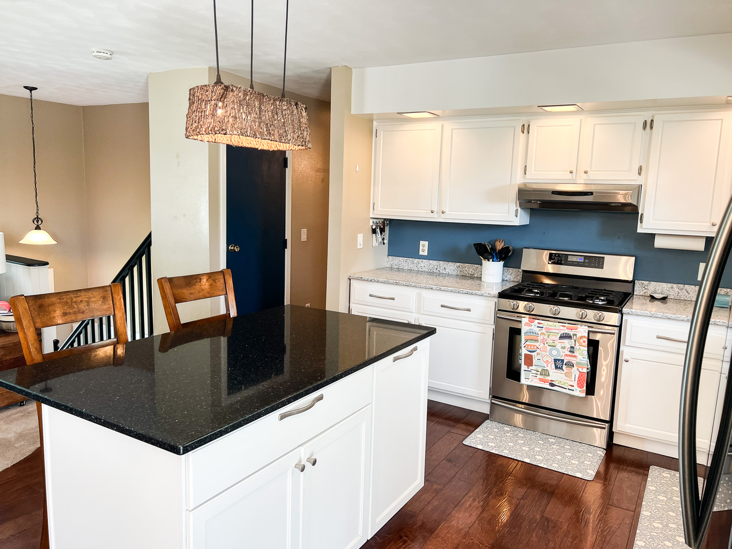 2201 Oak Drive Eureka, IL 61530 - Photo 21 of 25 a kitchen with granite countertop a stove a sink dishwasher and a refrigerator with wooden floor