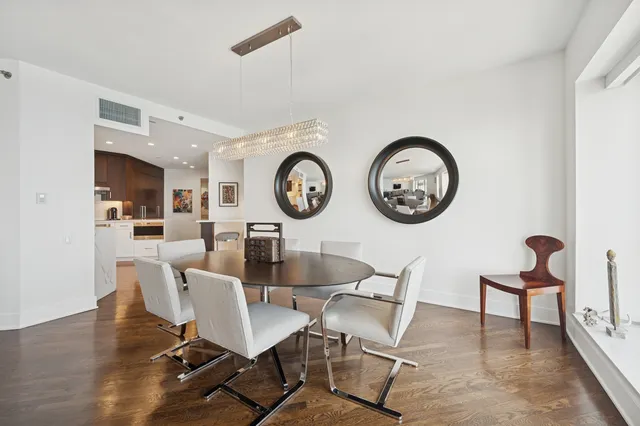 a view of a dining room with furniture and kitchen view