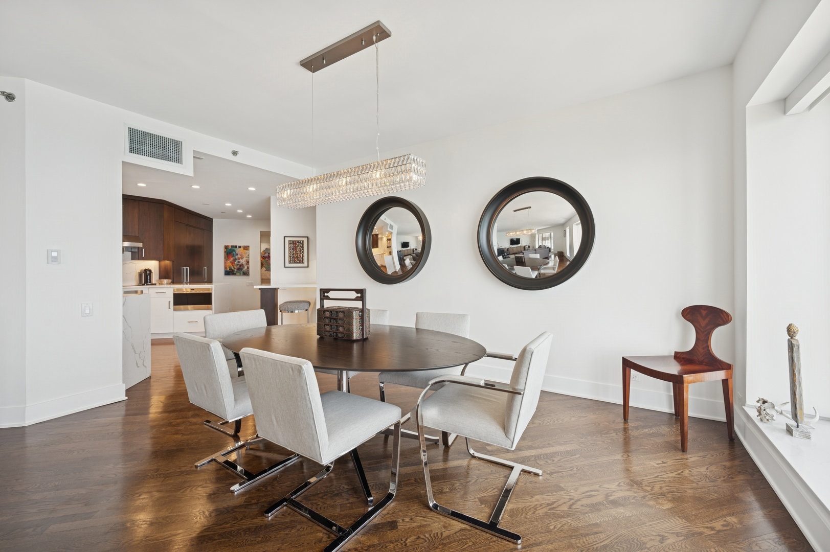 950 North Michigan Avenue, Unit 3705 Chicago, IL 60611 - Photo 11 of 47 a view of a dining room with furniture and kitchen view