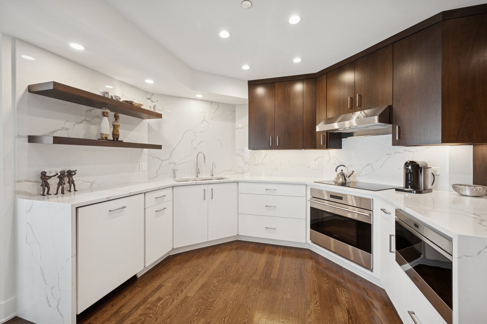 950 North Michigan Avenue, Unit 3705 Chicago, IL 60611 - Photo 14 of 47 a large white kitchen with stainless steel appliances granite countertop a stove a sink and a microwave