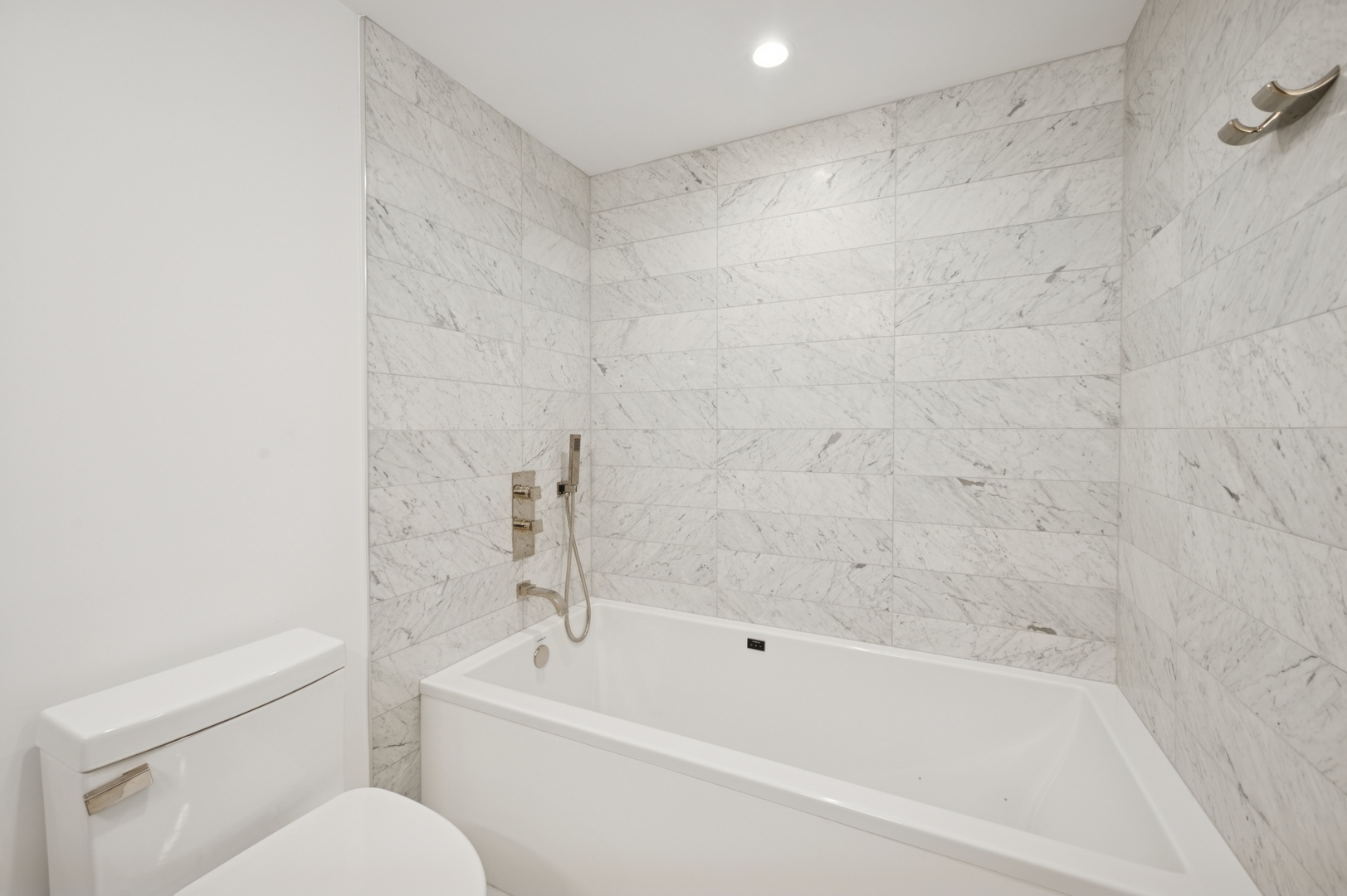 950 North Michigan Avenue, Unit 3705 Chicago, IL 60611 - Photo 22 of 47 a bathroom with a bathtub and a toilet