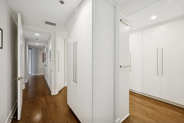 a view of a hallway with wooden floor