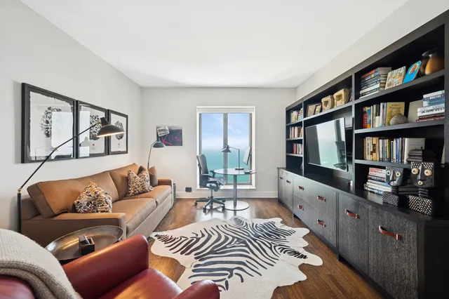 a living room with furniture and a book shelf