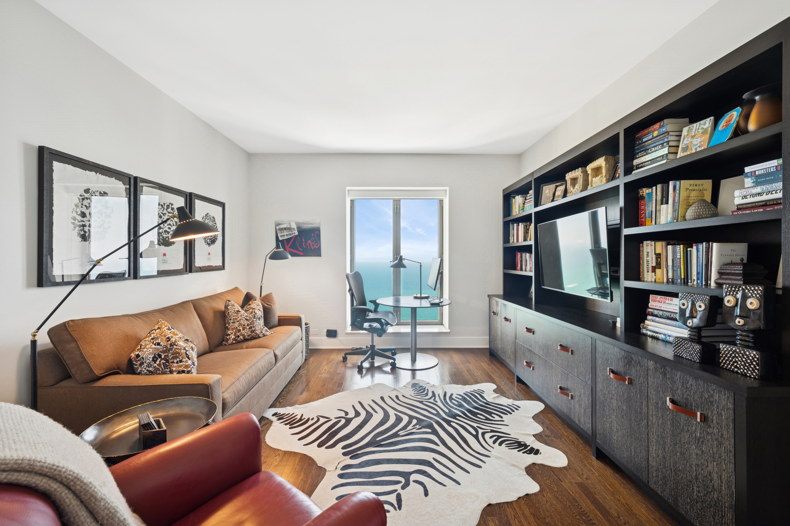 950 North Michigan Avenue, Unit 3705 Chicago, IL 60611 - Photo 27 of 47 a living room with furniture and a book shelf