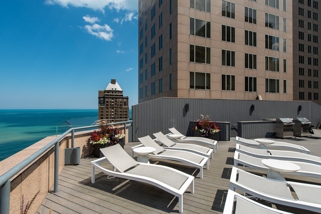 950 North Michigan Avenue, Unit 3705 Chicago, IL 60611 - Photo 38 of 47 a balcony with table and chairs