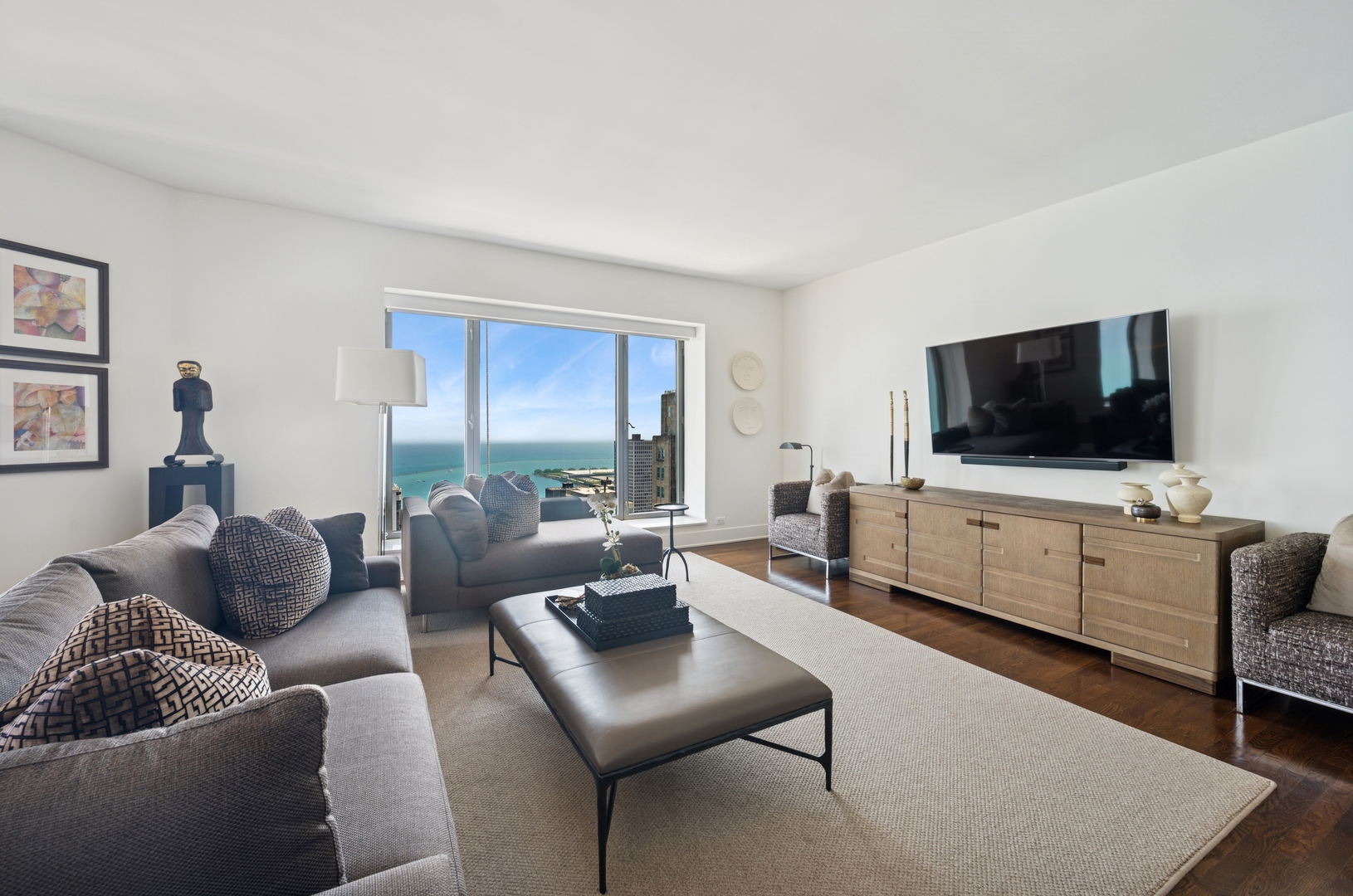 950 North Michigan Avenue, Unit 3705 Chicago, IL 60611 - Photo 7 of 47 a living room with furniture and a flat screen tv