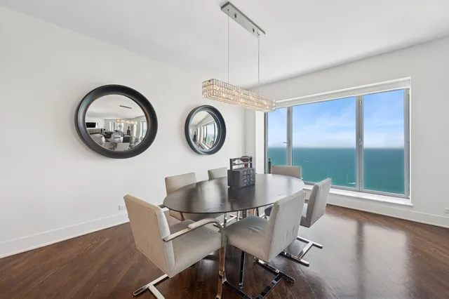 a view of a dining room with furniture window and wooden floor