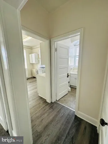 a view of a room with wooden floor and cabinet