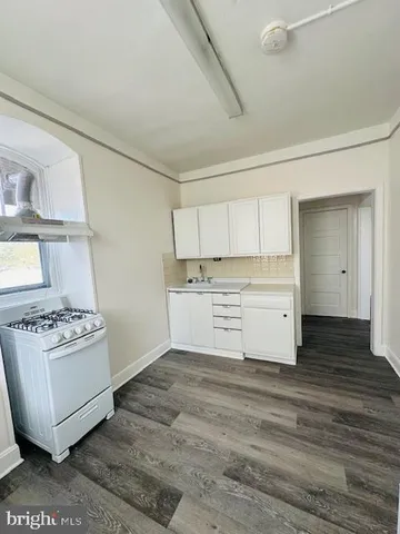 a view of a kitchen with a sink dishwasher and a refrigerator