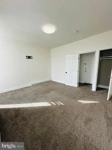 an empty room with closet area