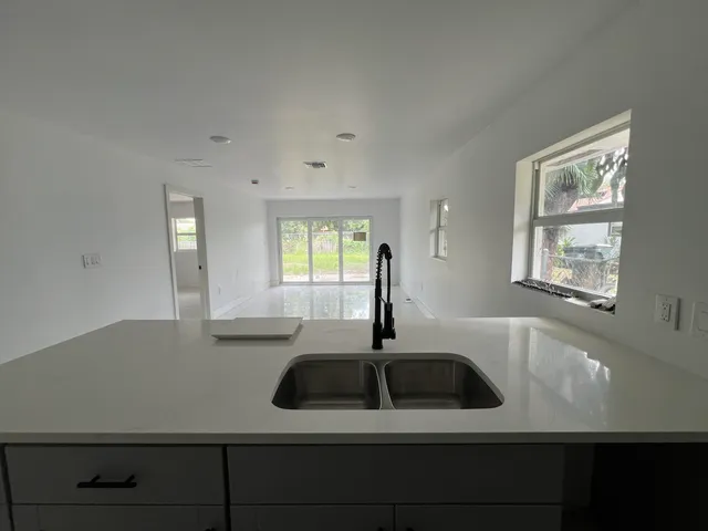 a kitchen with a sink and large window